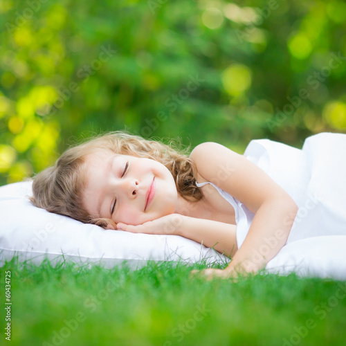 Child sleeping in spring garden