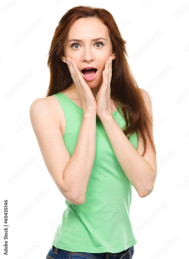 Woman is holding her face in astonishment Woman is holding her face in astonishment