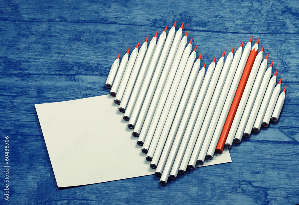 Fototapeta premium Pencils in a heart shape with place for text