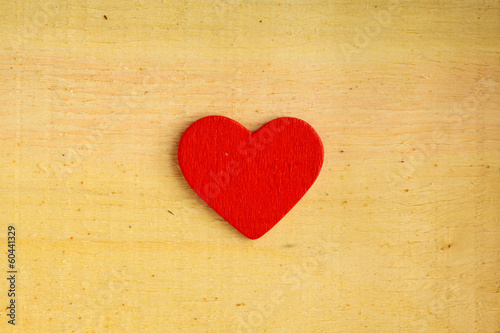 Red decorative heart on wooden background texture