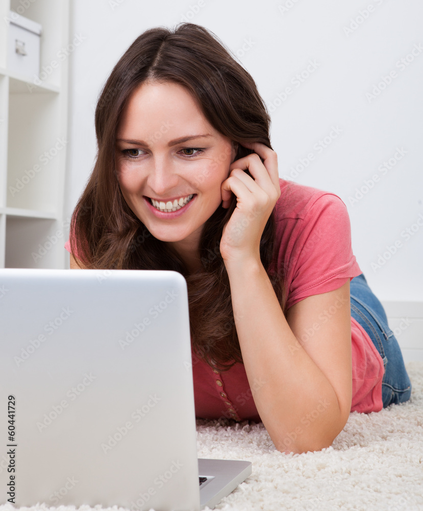Woman Lying On Floor In Front Of Laptop Woman Lying On Floor In Front Of Laptop