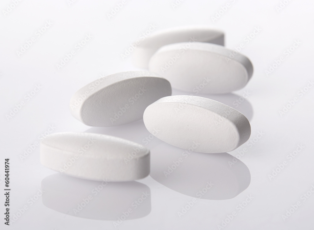 White pills on acrylic background White pills on acrylic background