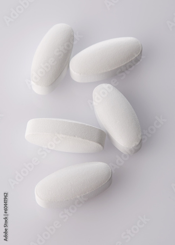 White pills on acrylic background