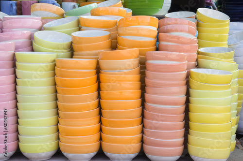 Stacks of colorful bowl in warehouse