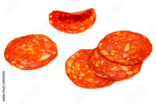 Sliced chorizo sausage isolated on a white studio background.
