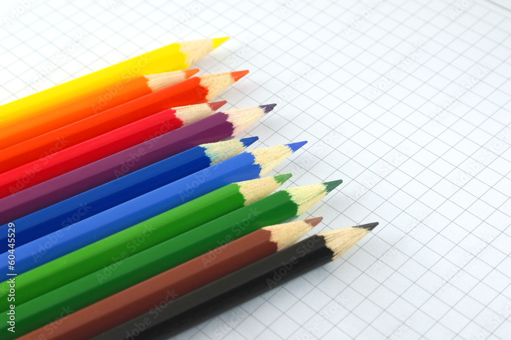 Color pencils on the checked paper Color pencils on the checked paper