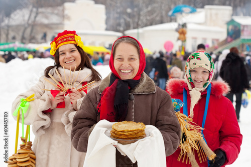 Mature woman with pancake during  Shrovetide photo