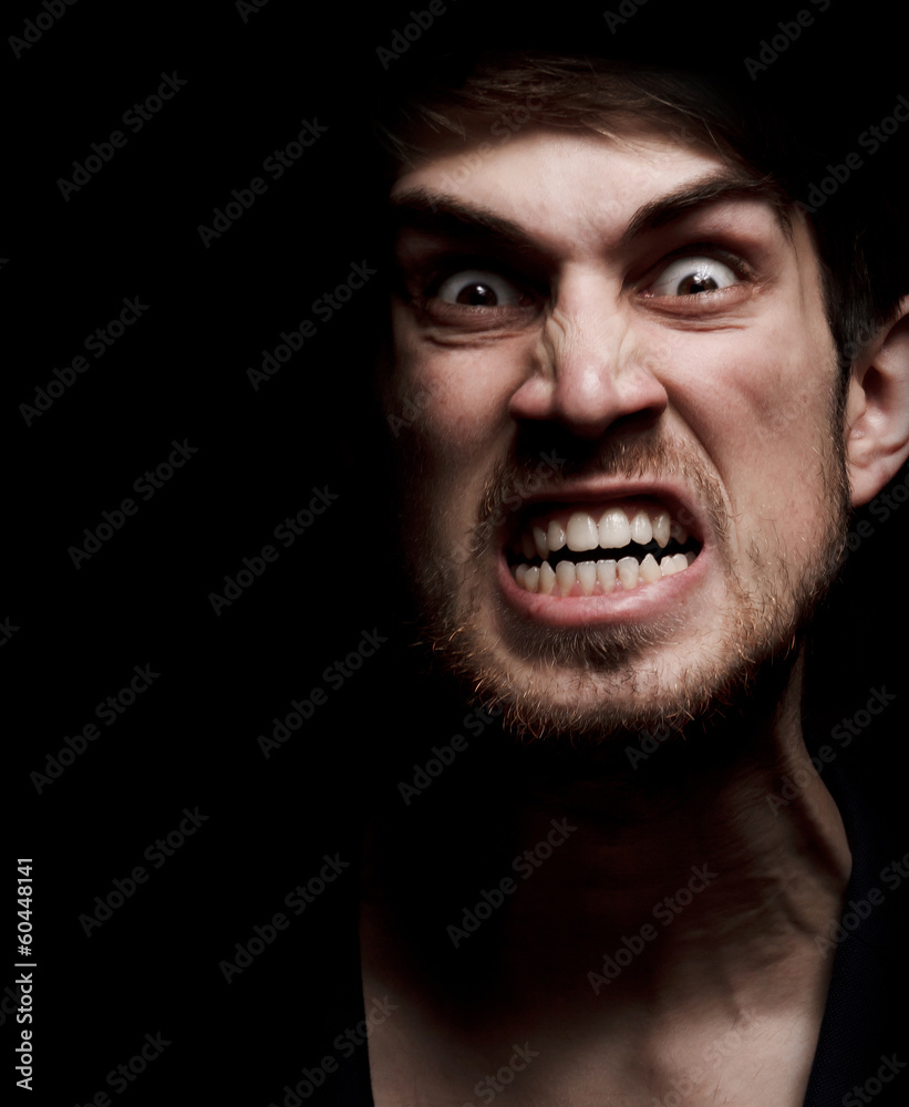Angry man with grin in the dark Angry man with grin in the dark
