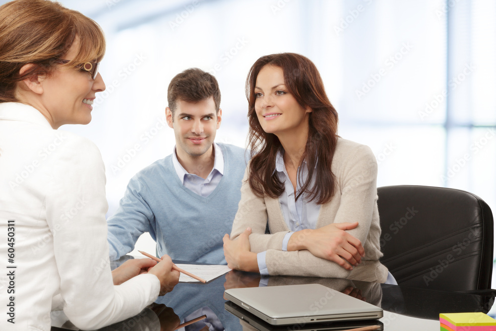 Young couple discussing financial plan with consultat Young couple discussing financial plan with consultat
