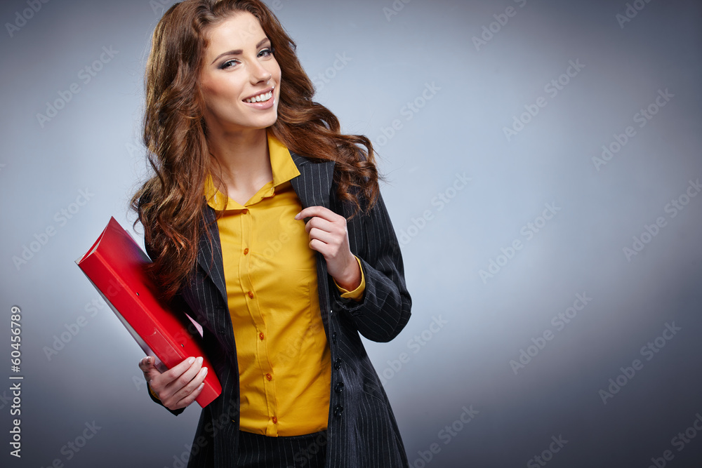 Naklejka premium picture of a young attractive businesswoman with folders