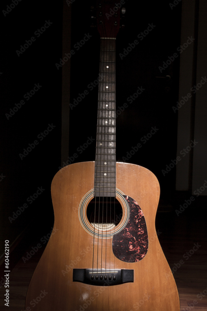 Old guitar laid against the wall Old guitar laid against the wall