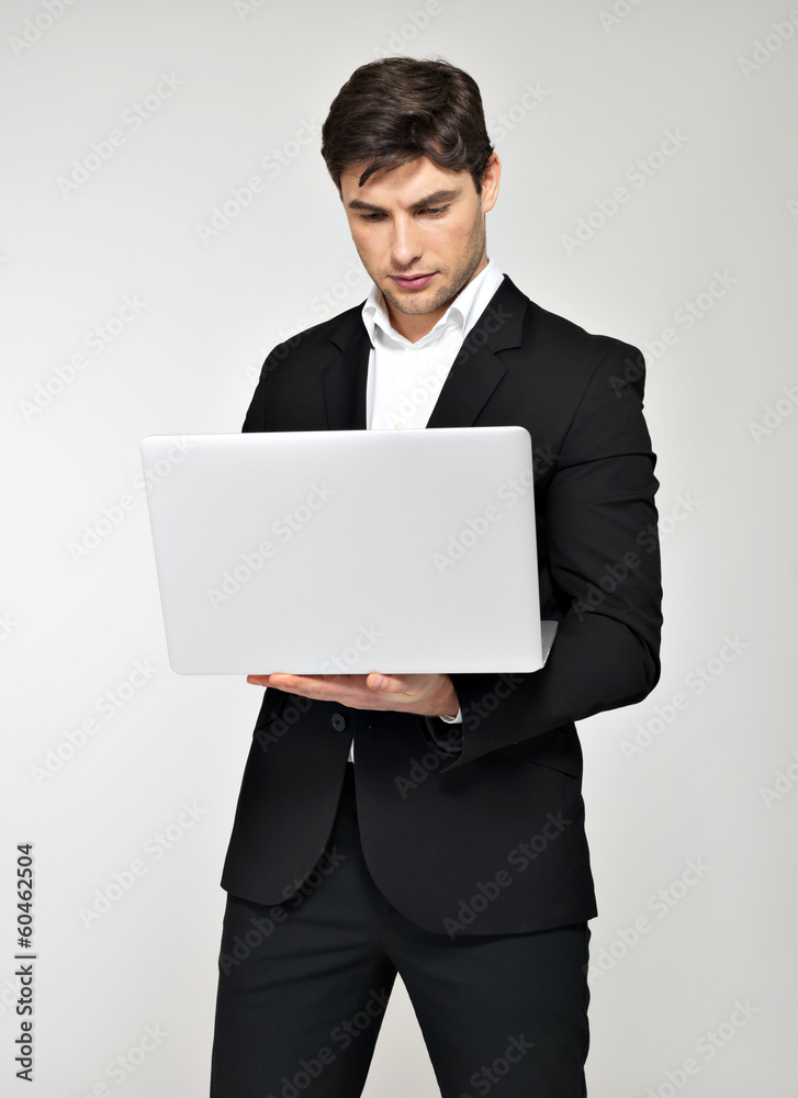 Portrait of young man with laptop  in casuals