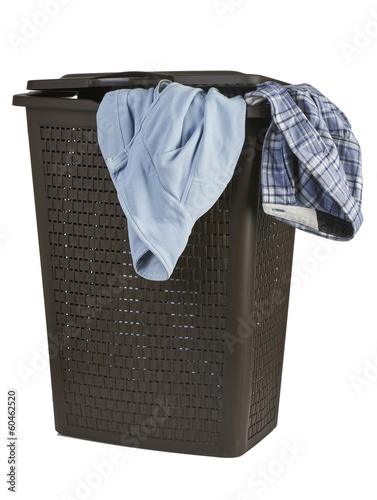 Bright clothes in a laundry closed basket on white background
