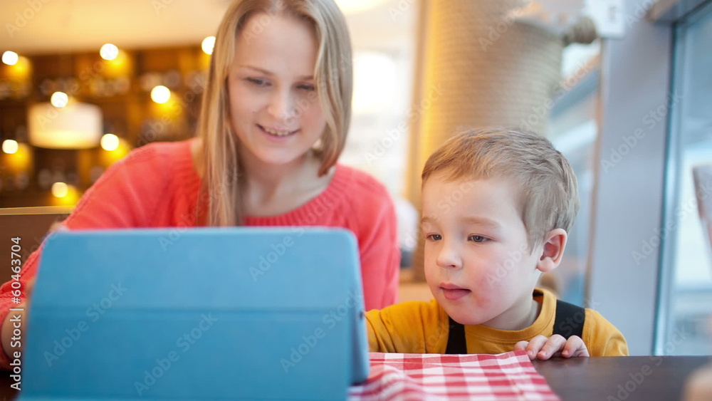Mother and her son with touchpad Mother and her son with touchpad