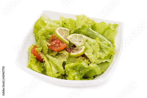 Plate with salad on white background
