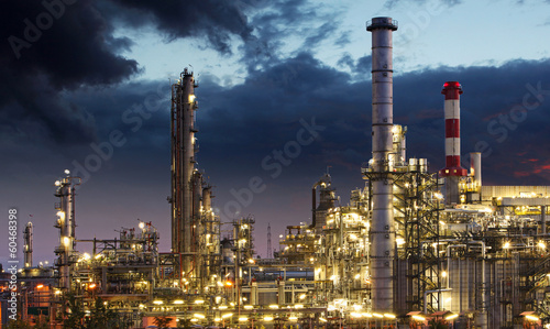 Oil refinery factory silhouette over sunrise