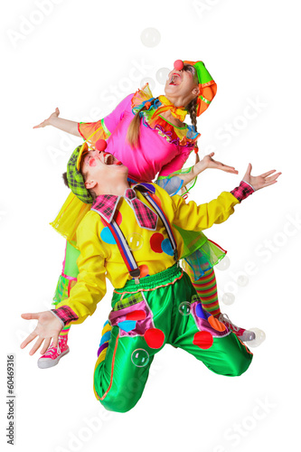 Two cheerful clowns in the soap bubbles isolated on a white