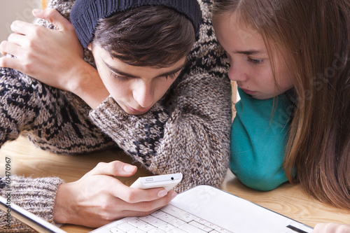 boy and girl chatting on mobile phone photo