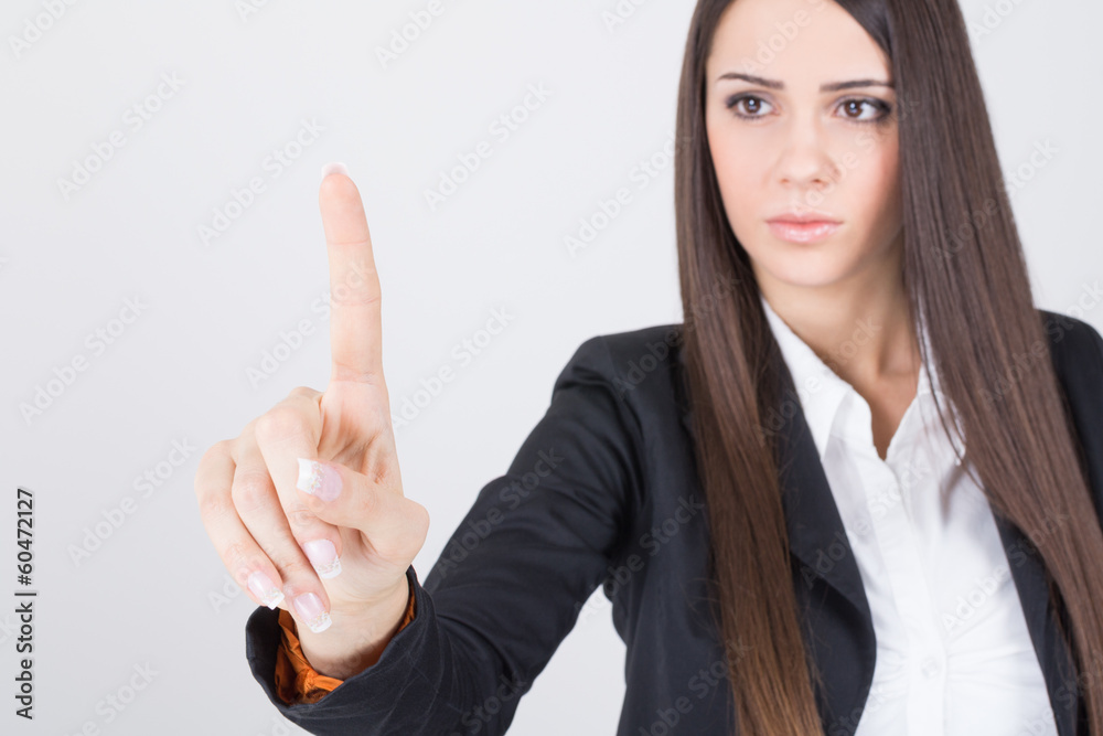 Young businesswoman pointing with finger Young businesswoman pointing with finger