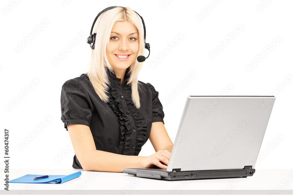 Young female customer service operator working on laptop Young female customer service operator working on laptop