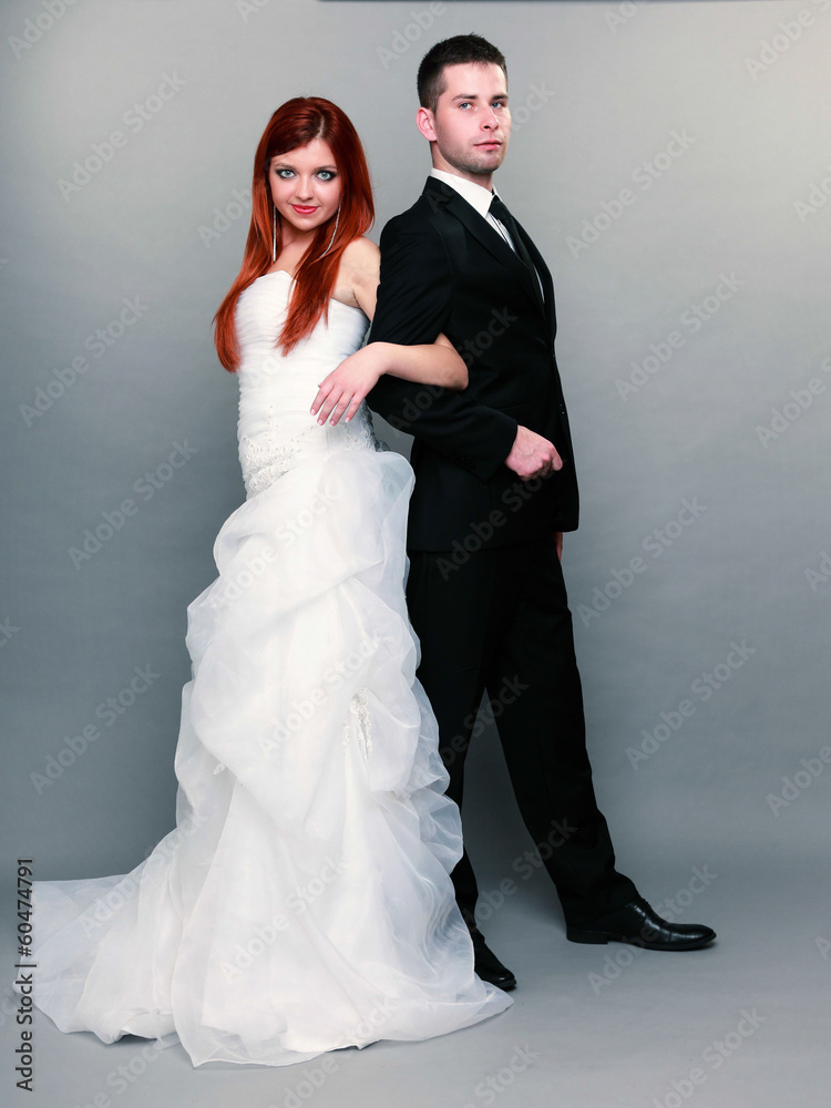 Happy married couple bride groom on gray background Happy married couple bride groom on gray background