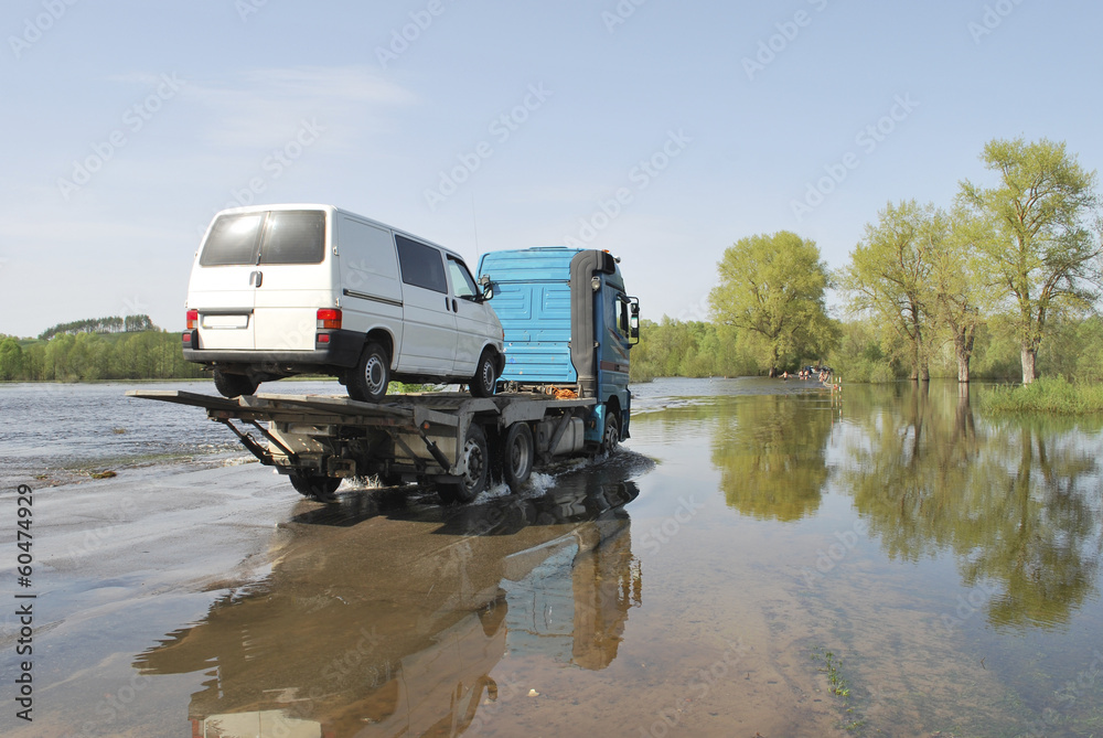 truck transports passenger car which appeared over the river ban