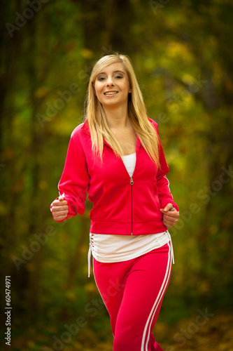 Fototapeta Naklejka Na Ścianę i Meble -  girl young woman running jogging in autumn fall forest park