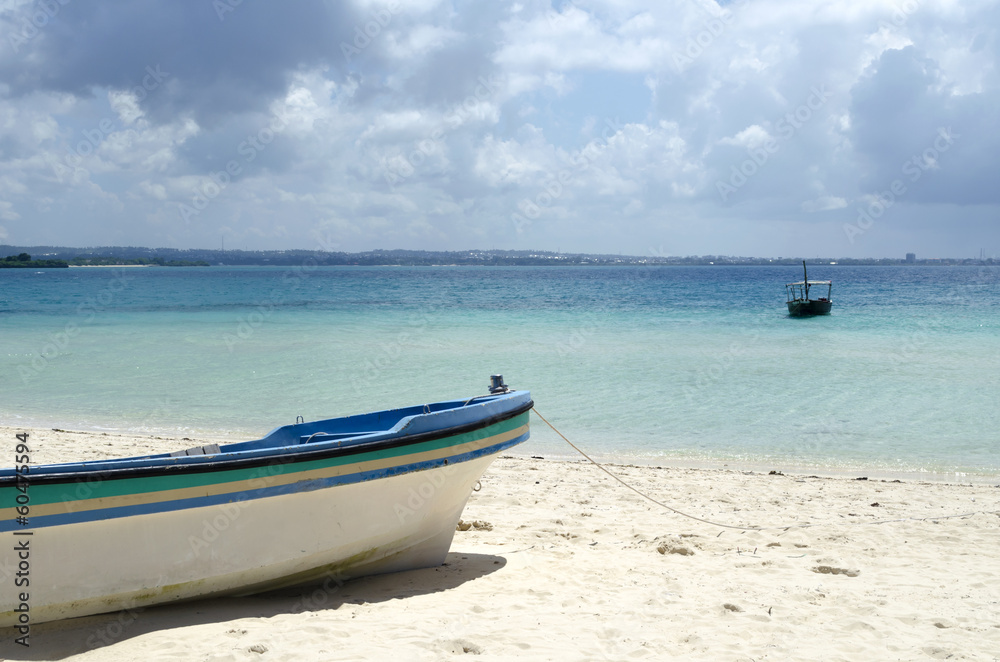 Fisherman boat on the beach with blue sky in Zanzibar, Tanzania