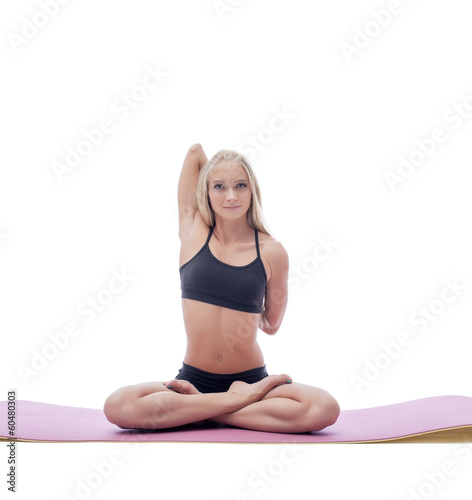 Flexible young blonde doing yoga in studio