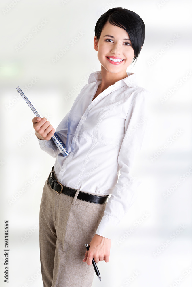 Happy smiling business woman holding notebook and pen Happy smiling business woman holding notebook and pen