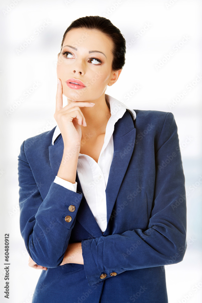Young thoughtful businesswoman looking on side Young thoughtful businesswoman looking on side