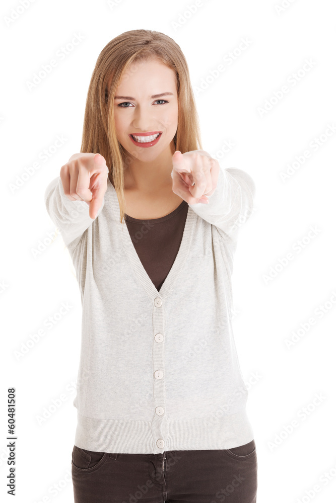 Beautiful casual woman pointing on you, advertising. Beautiful casual woman pointing on you, advertising.
