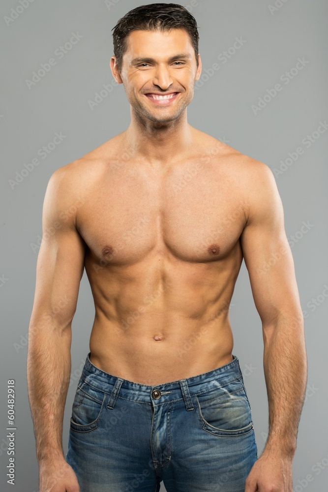 Handsome young man in blue jeans with naked torso