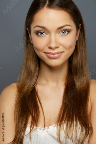 Beautiful girl with long hair isolated on grey