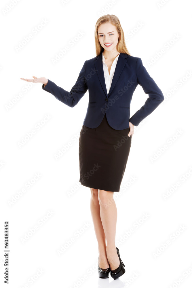 Business woman showing empty space on her palm. Business woman showing empty space on her palm.
