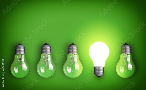 Idea concept with row of light bulbs and glowing bulb photo
