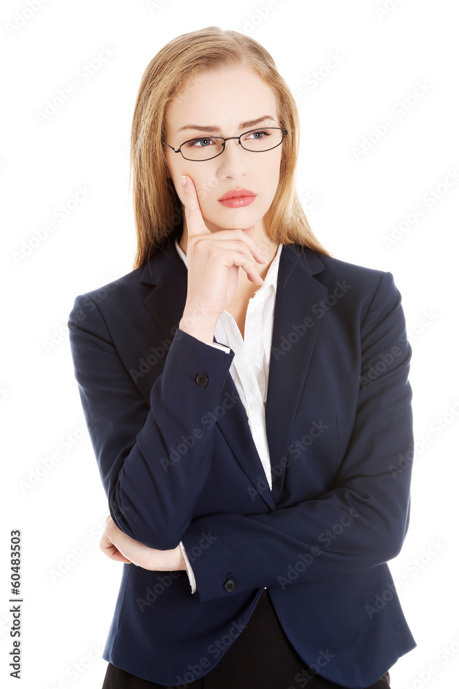Beautiful business woman with her finger on cheek thinking. Beautiful business woman with her finger on cheek thinking.