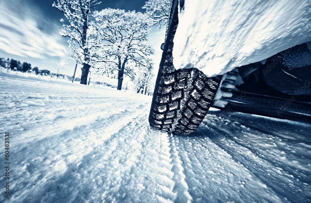 Naklejka premium Car tires on winter road