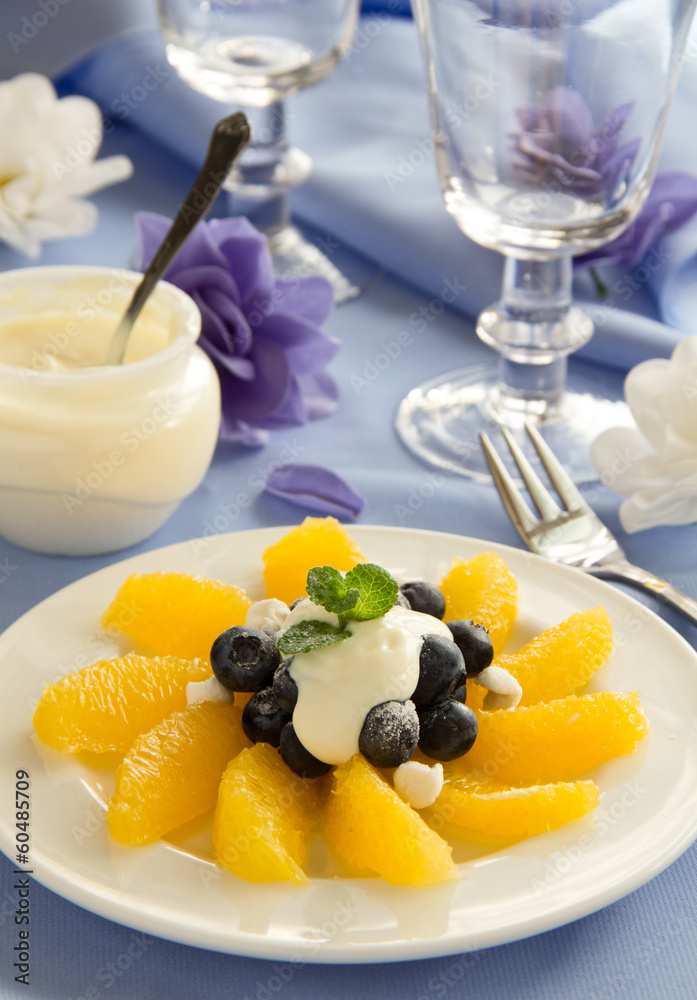 Delicious fruit salad with oranges, blueberries and cream. Delicious fruit salad with oranges, blueberries and cream.