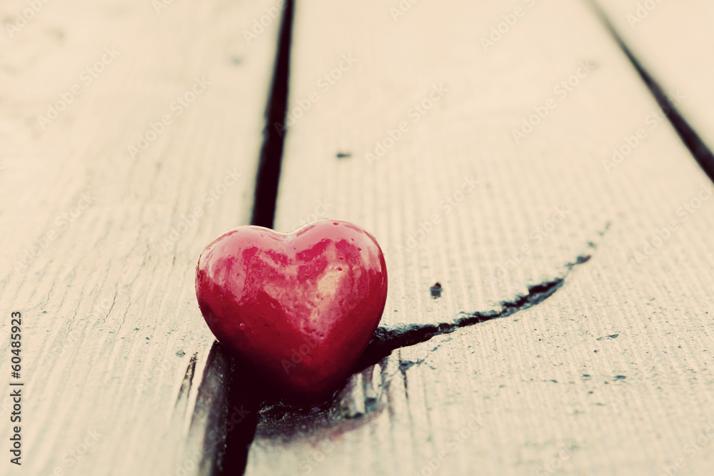 Red heart in crack of wooden plank. Symbol of love. Vintage Red heart in crack of wooden plank. Symbol of love. Vintage