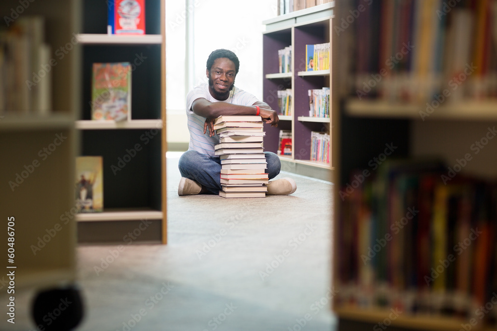 Student With Books And Digital Tablet Sitting In Library Student With Books And Digital Tablet Sitting In Library