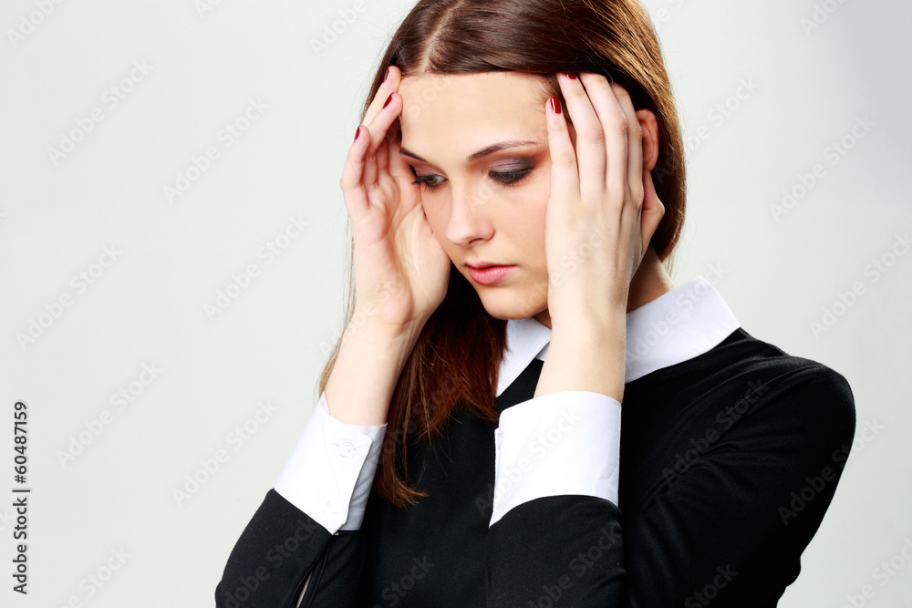 Portrait of a young woman touching her head with headache Portrait of a young woman touching her head with headache
