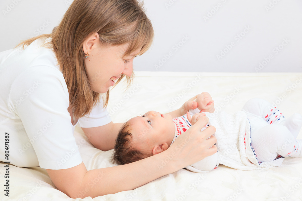mother enjoying time with newborn daughter mother enjoying time with newborn daughter