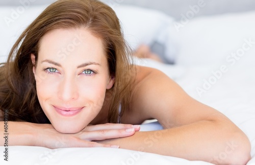 Close-up portrait of a pretty woman lying in bed