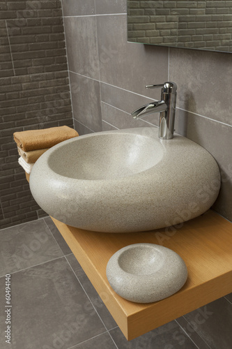 detail of a modern bathroom with sink and faucet photo