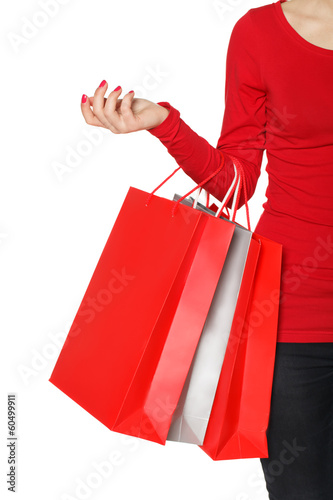 Close up woman hand with many shopping bags and credit card.