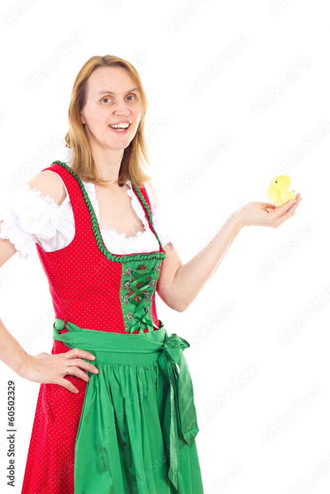 Girl wearing red dirndl and holding tiny chick in her hand Girl wearing red dirndl and holding tiny chick in her hand