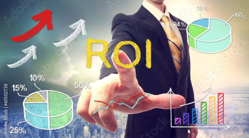 Businessman touching ROI (return on investment) photo