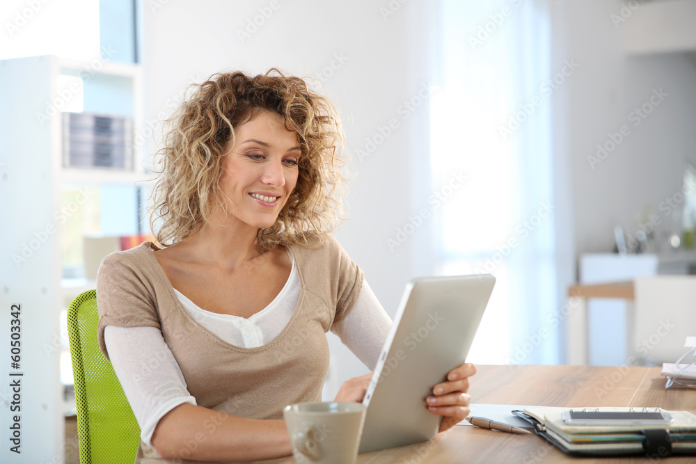 Woman in homr-office using tablet Woman in homr-office using tablet