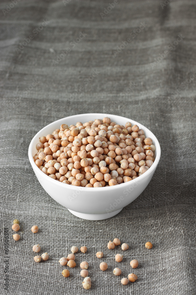 Organic chickpeas on sackcloth in ceramic bowl Organic chickpeas on sackcloth in ceramic bowl